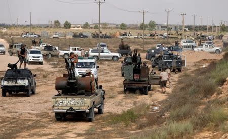 Libyan forces allied with the U.N.-backed government look at Islamic State fighters' positions before a battle in Sirte. REUTERS/Goran Tomasevic