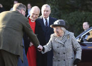 Britain's Queen Elizabeth II, right, arrives at St Mary the Virgin, in Hillington, England, to attend a Sunday church service, Sunday, Jan. 19, 2020. Buckingham Palace says Prince Harry and his wife, Meghan, will no longer use the titles "royal highness" or receive public funds for their work under a deal that allows them to step aside as senior royals. Prince Andrew is at background centre. (Joe Giddens/PA via AP)