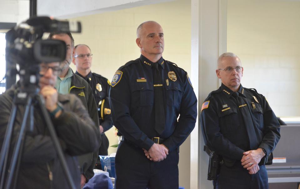 Orleans Police Chief Scott MacDonald, center, and Yarmouth Police Chief Kevin Lennon, right, listen to speakers during Monday's press conference iin Barnstable where Cape and Islands District Attorney Robert Galibois announced efforts to eradicate human trafficking and combat the opioid crisis and illegal narcotics activity.