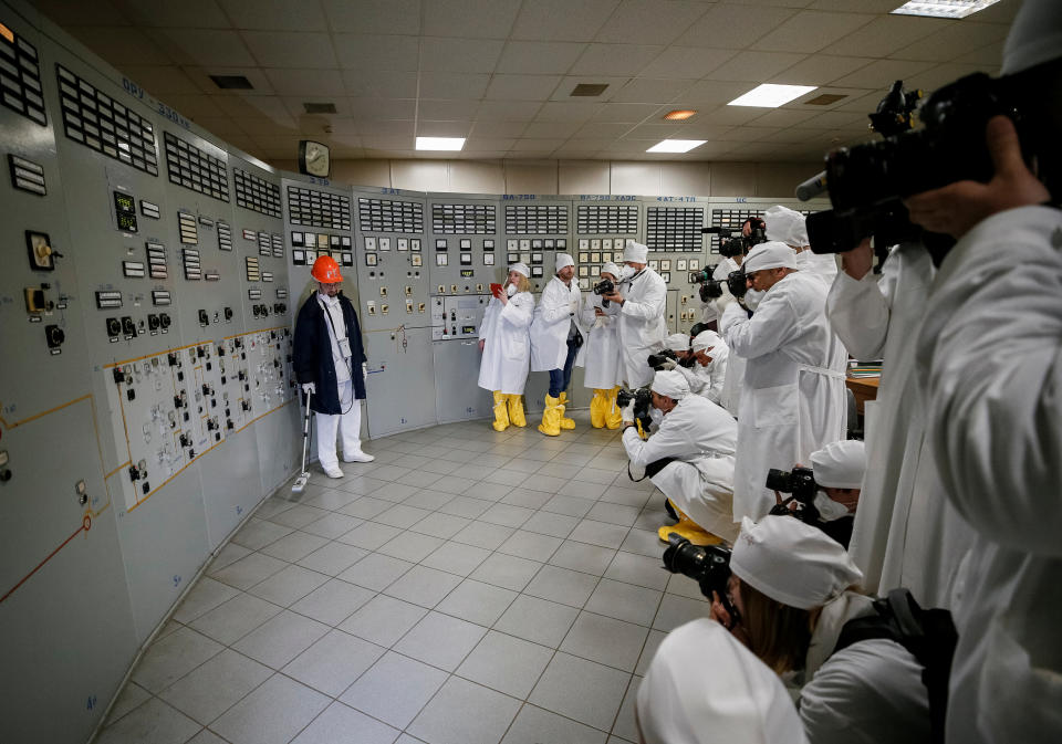 <p>An employee measures the radiation level as journalists take pictures at a control center of the stopped third reactor at the Chernobyl nuclear power plant in Chernobyl, Ukraine, April 20, 2018. (Photo: Gleb Garanich/Reuters) </p>