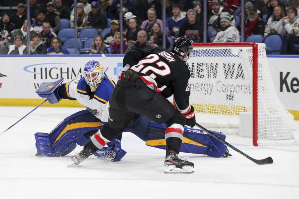 Buffalo Sabres right wing Jack Quinn (22) prepares to score around St. Louis Blues goaltender Jordan Binnington (50) during the third period of an NHL hockey game Wednesday, Nov. 23, 2022, in Buffalo, N.Y. (AP Photo/Joshua Bessex)