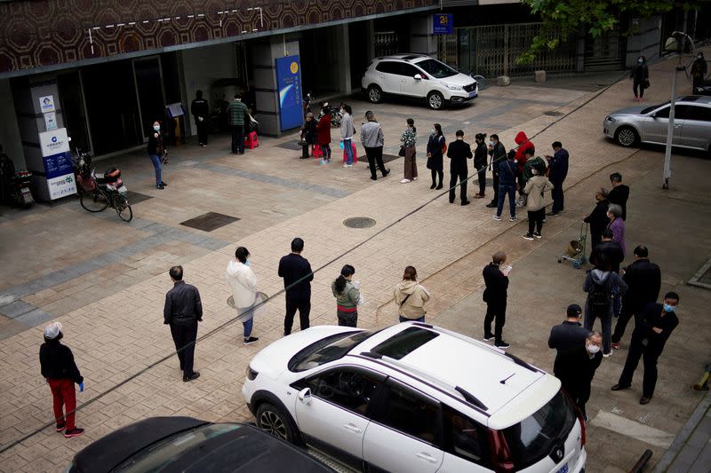 People line up outside a China Construction Bank branch in Wuhan