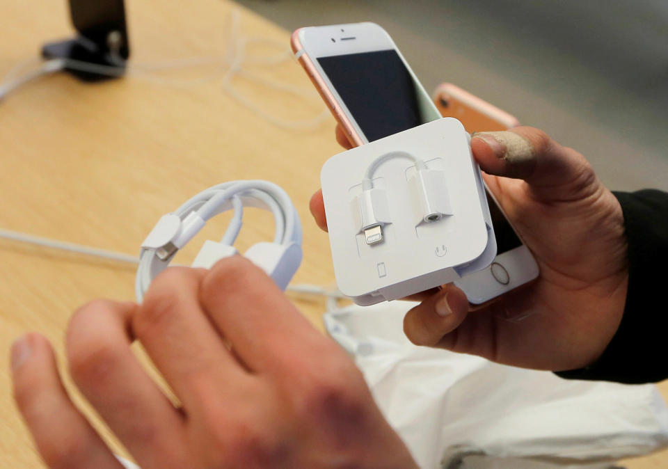 The new lightning port to headphone adaptor is pulled from the packaging of a new iPhone 7 at the Australian flagship Apple store in Sydney, September 16, 2016 as the iPhone 7 goes on sale for the first time. The iPhone 7 is the first model that does not feature a headphone jack. REUTERS/Jason Reed