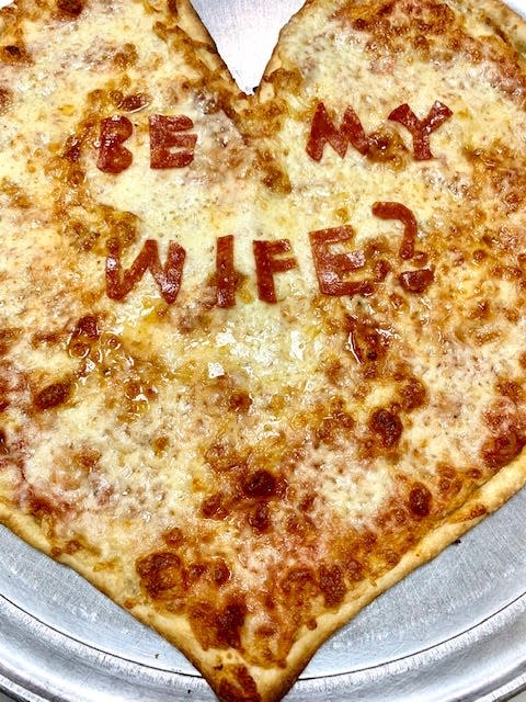 A man proposed to his girlfriend at Franco's Metro with a pizza that spelled out "Be My Wife?" in pepperoni.