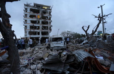 Somali government soldiers stand outside the ruins of the Jazeera hotel after an attack in Somalia's capital Mogadishu, July 26, 2015. REUTERS/Feisal Omar