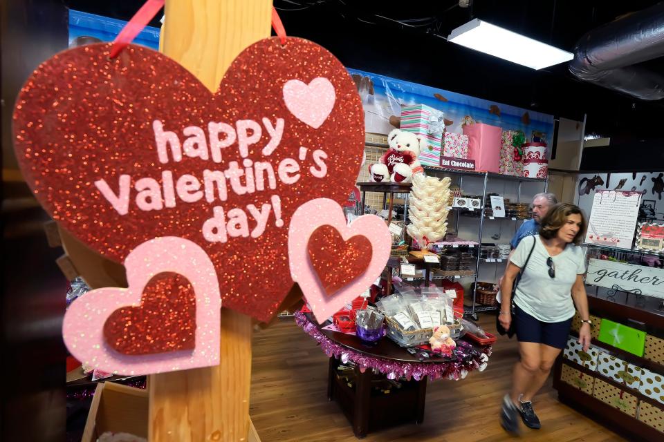 Customers shop for Valentine's Day gifts at Angell & Phelps Chocolate Factory in Daytona Beach. Business leading up to the holiday has been "exceptionally busy," according to one employee.