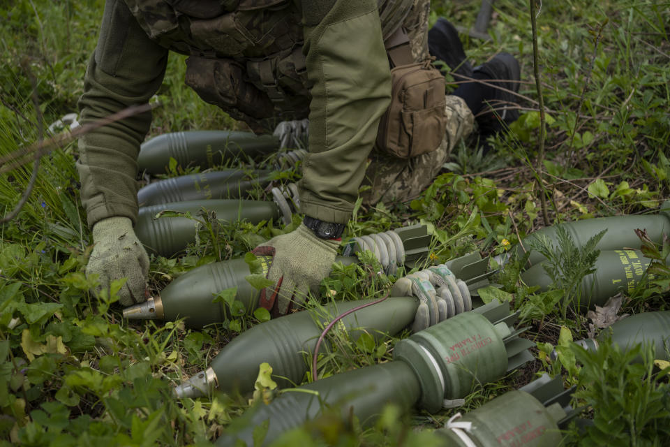 A Ukrainian serviceman prepares to fire a mortar toward Russian positions in the east Kharkiv region, Ukraine, Tuesday, May 17, 2022. (AP Photo/Bernat Armangue)