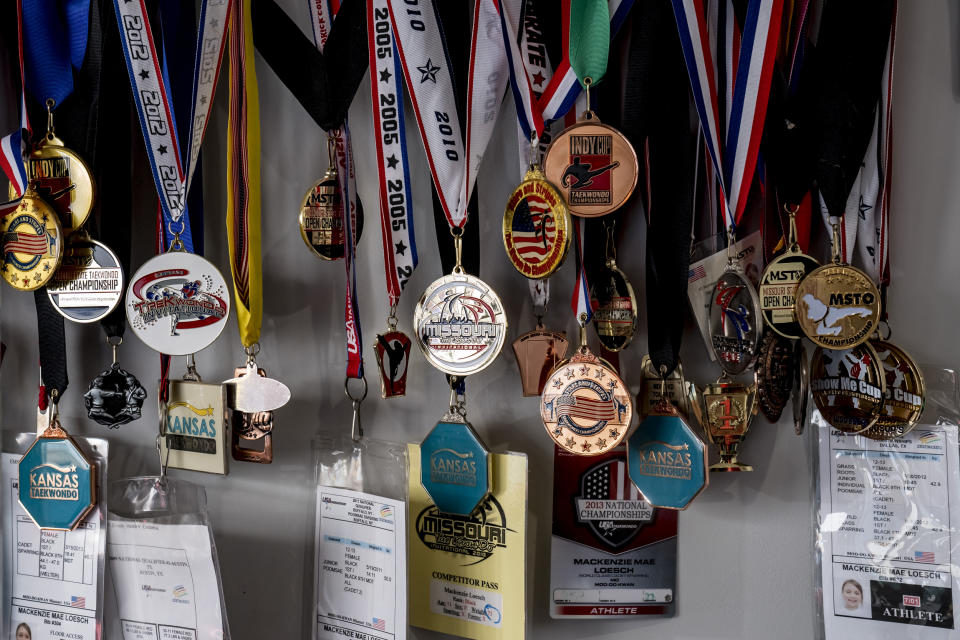 Taekwondo medals belonging to MacKenzie Loesch hang on a wall in her home gym in Marthasville, Mo. (Whitney Curtis for NBC News)