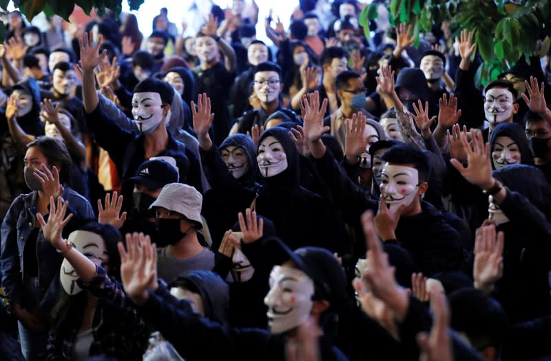 Protesters wearing Guy Fawkes masks attend an anti-government demonstration in Hong Kong