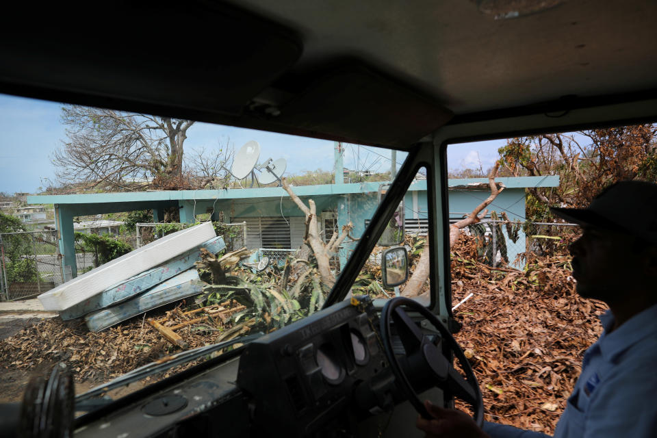 <p>Luis Menendez, a mail man for the U.S. Postal Service, delivers mail at an area affected by Hurricane Maria in the island of Vieques, Puerto Rico, Oct. 7, 2017. (Photo: Carlos Barria/Reuters) </p>