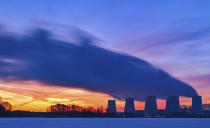 Steams rise from towers of the J'nschwalde lignite-fired power plant in Peitz, Brandenburg, Germany, Wednesday, Jan. 17, 2024. (Patrick Pleul/dpa via AP)