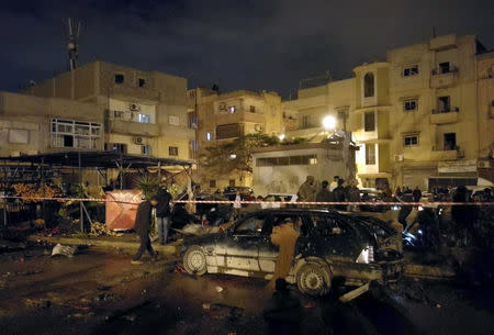 People gather at the site of twin car bombs in Benghazi, Libya, January 23, 2018. Picture taken January 23, 2018. REUTERS/Stringer