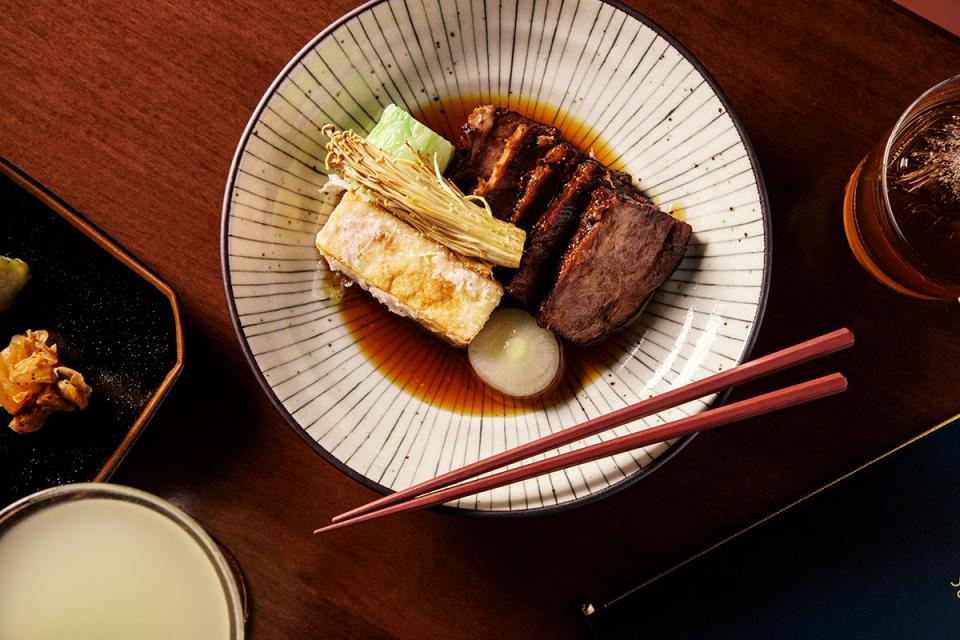 <cite class="credit"><em>Photo by Grant Harder</em> | Slow-cooked organic chuck flat, chickpea tofu, cipollini, enoki, salted napa cabbage in a sukiyaki broth at Kissa Tanto</cite>