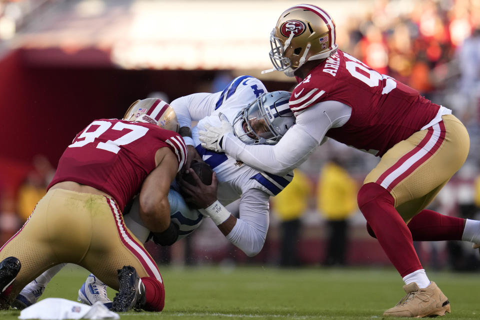 Dallas Cowboys quarterback Dak Prescott, middle, is sacked by San Francisco 49ers defensive end Nick Bosa (97) and defensive end Arik Armstead during the first half of an NFL football game in Santa Clara, Calif., Sunday, Oct. 8, 2023. (AP Photo/Godofredo A. Vásquez)