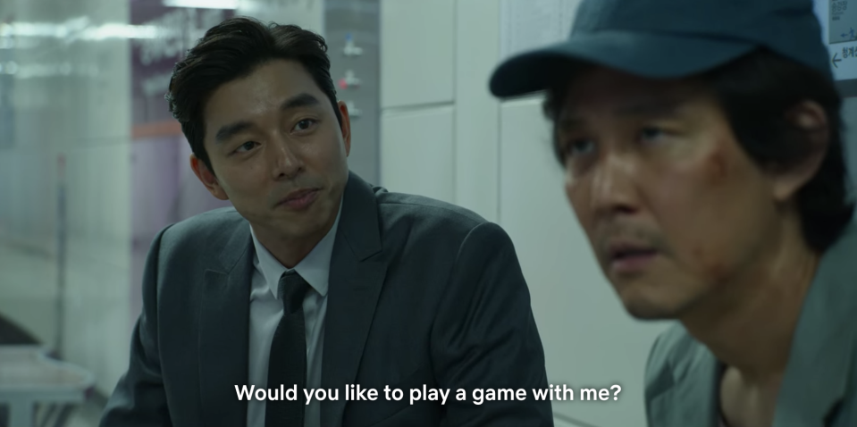 A man asking Gi-hun if he wants to play a game