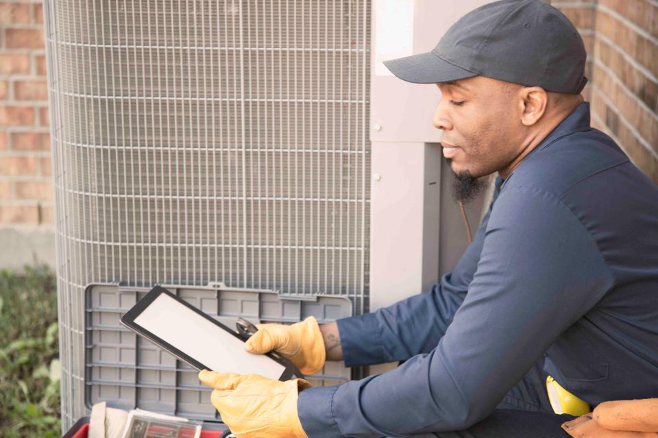 HVAC Technician Checking HVAC Unit