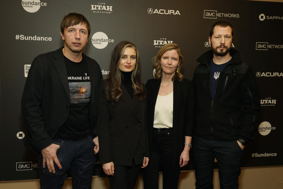 Associated Press video journalist Mstyslav Chernov, right, the director/producer/cinematographer of the documentary film "20 Days in Mariupol," poses with, from left, AP photographer Evgeniy Maloletka, AP field producer Vasilisa Stepanenko and "Frontline" producer/editor Michelle Mizner at the world premiere of the film at the 2023 Sundance Film Festival, Friday, Jan. 20, 2023, in Park City, Utah. (AP Photo/Chris Pizzello)