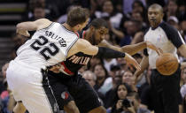 San Antonio Spurs' Tiago Splitter (22), of Brazil, pressures Portland Trail Blazers' LaMarcus Aldridge during the first half of Game 1 of a Western Conference semifinal NBA basketball playoff series, Tuesday, May 6, 2014, in San Antonio. (AP Photo/Eric Gay)