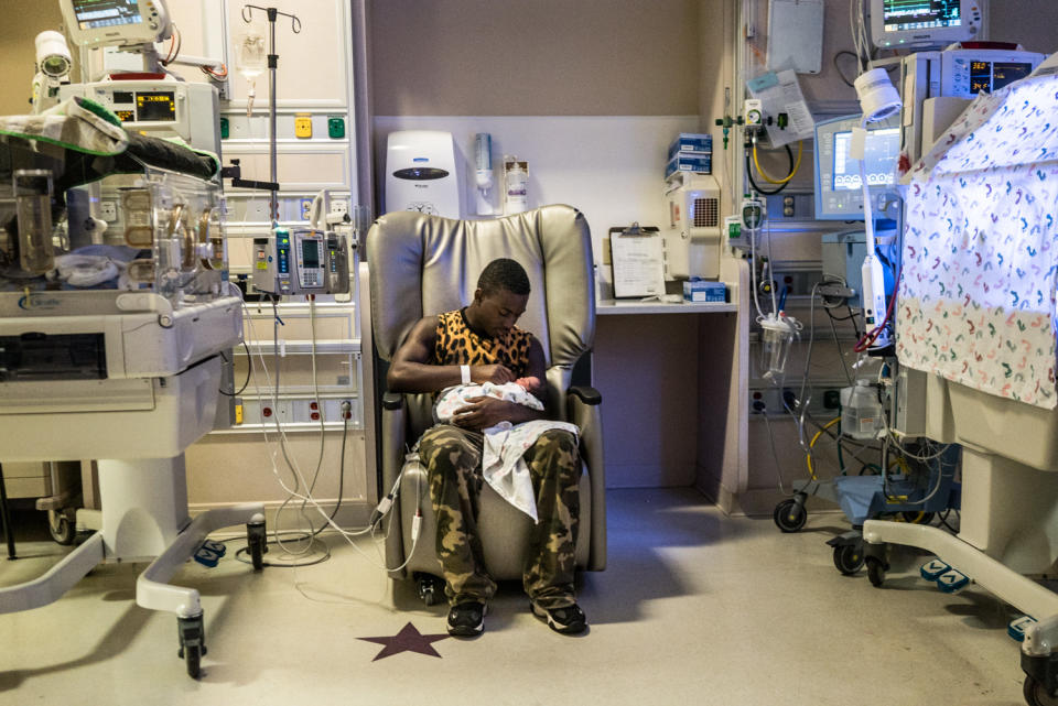 <p>Dusable Lewis, 17, holds his newborn child Dusable Jr. at Hurley’s Hospital in Flint, Mich. This is Lewis’ second child and despite being born premature, Junior is healthy. Lewis, who everyone calls Peanut, is the little brother of Claressa and Briana Shields. (Photograph by Zackary Canepari) </p>