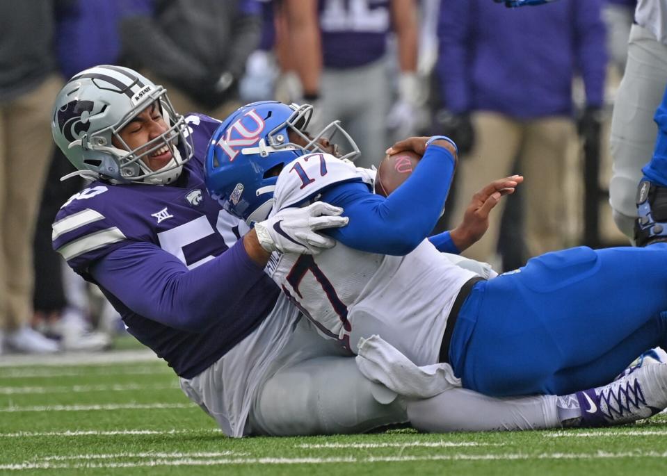 Kansas State defensive end Tyrone Taleni sacks Kansas quarterback Jalon Daniels during a game in October 2020.