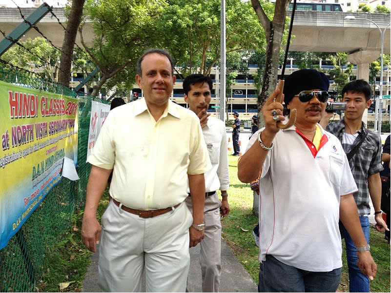 Reform Party's Kenneth Jeyaretnam arrives, flanked by supporters.