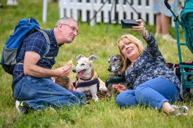 A couple take a selfie with their pet