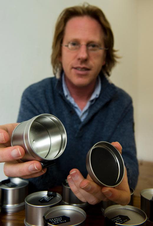 US conceptual artist Jonathon Keats holds up one of his "Century Cameras" ahead of the opening of his Century Camera project at a gallery in Berlin May 15, 2014