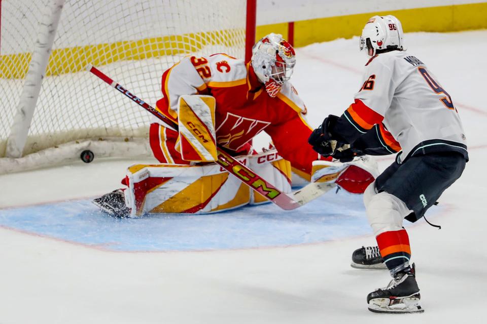 Coachella Valley Firebirds forward Logan Morrison (96) scores against Calgary Wranglers goaltenders Dustin Wolf during an overtime shootout at Acrisure Arena in Palm Desert, Calif., on Wednesday, Jan. 31, 2024.