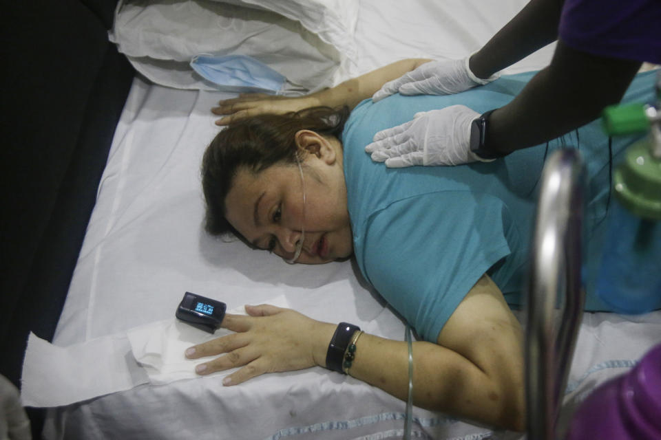 Maricar Tajo, 46, who is from the Philippines but moved to Nigeria in 2007 for work, receives oxygen from a private medical service at her house as she recovers from COVID-19 in Lagos, Nigeria Saturday, Feb. 6, 2021. She was resuscitated after falling unconscious in a hospital intensive care unit when her oxygen saturation levels dropped. (AP Photo/Sunday Alamba)