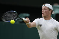 Tim van Rijthoven of the Netherlands returns the ball to Serbia's Novak Djokovic during a men's fourth round singles match on day seven of the Wimbledon tennis championships in London, Sunday, July 3, 2022.(AP Photo/Kirsty Wigglesworth)