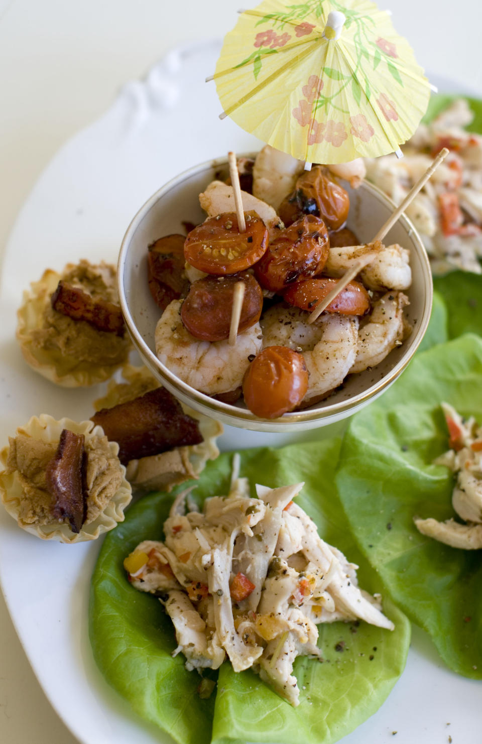 This Nov. 18, 2013 photo shows roasted shrimp cocktail, pinapple chicken lettuce wraps, and Elvis phyllo cups in Concord, N.H. (AP Photo/Matthew Mead)