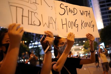 Protesters attend a "Stand With Hong Kong, Power to the People Rally" at the Chater Garden, in Hong Kong