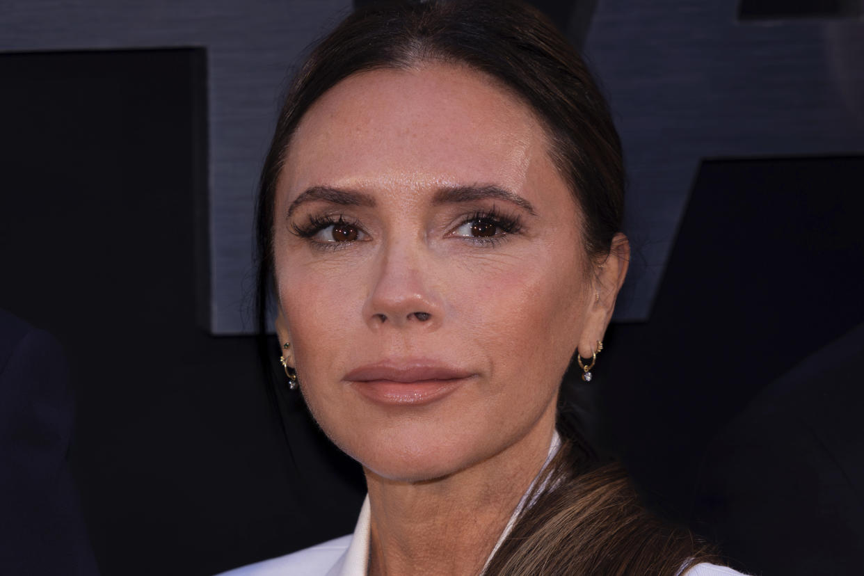 Victoria Beckham poses in a white suit at Beckham documentary red carpet