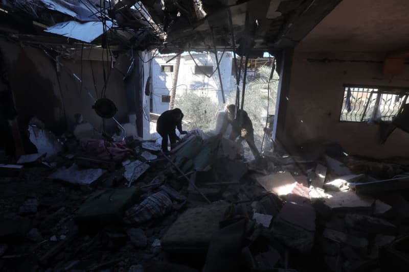 Palestinians inspect damaged buildings after the Israeli army launched an attack on houses. Naaman Omar/APA Images via ZUMA Press Wire/dpa