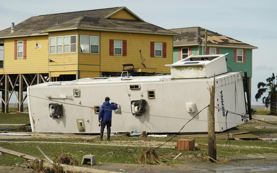 A journalist photographs damage left in the wake of Hurricane Laura, Thursday, Aug. 27, 2020, in Holly Beach, La. (AP Photo/Eric Gay)