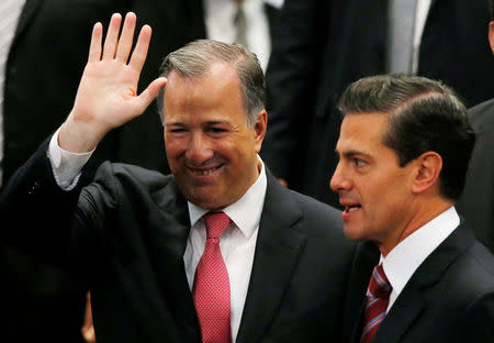 Mexico's outgoing Finance Minister Jose Antonio Meade waves next to President Enrique Pena Nieto during an event where Pena Nieto announced the resignation of Antonio Meade, at Los Pinos presidential residence in Mexico City, Mexico November 27, 2017. REUTERS/Henry Romero