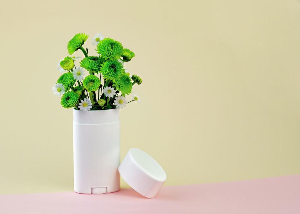 white and green flowers in a deodorant container