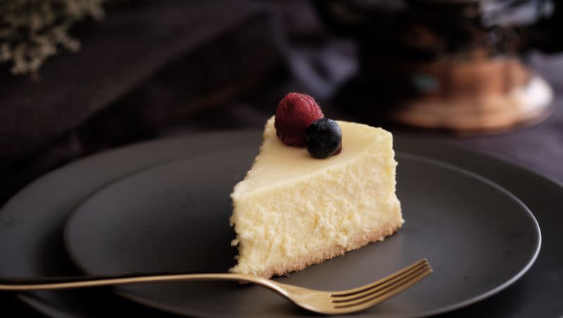 Photograph of cheesecake with berries on top.