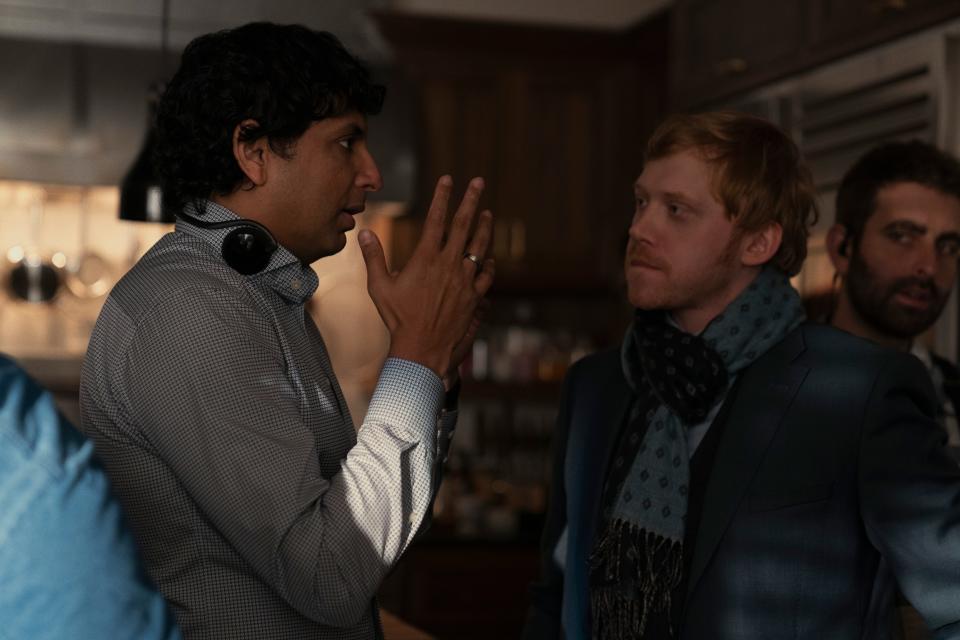 Director/producer M. Night Shyamalan, left, and Rupert Grint on the set of the Apple's new psychological thriller "Servant."