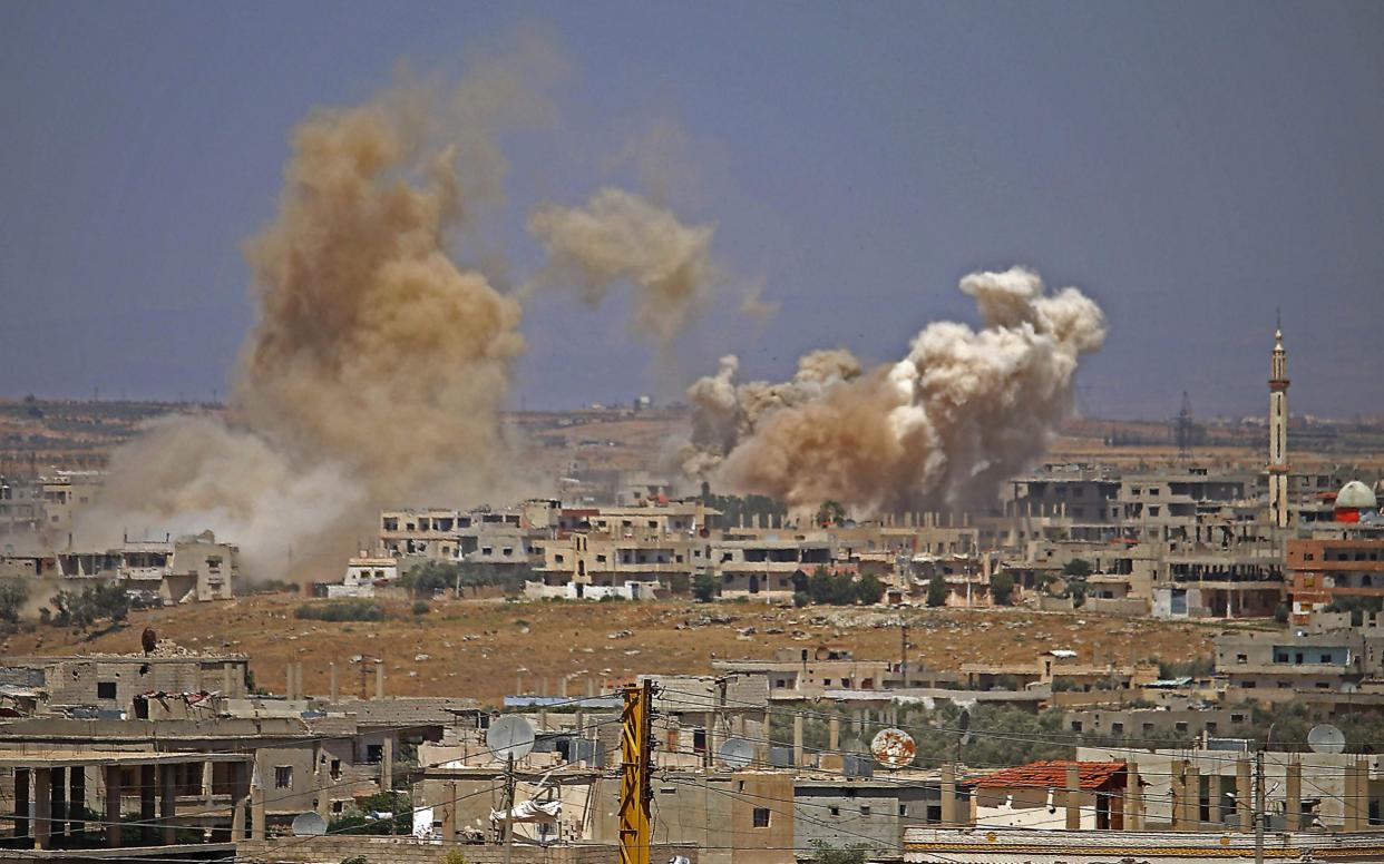 Smoke rises above opposition held areas of the city of Daraa during airstrikes by Syrian regime forces - AFP