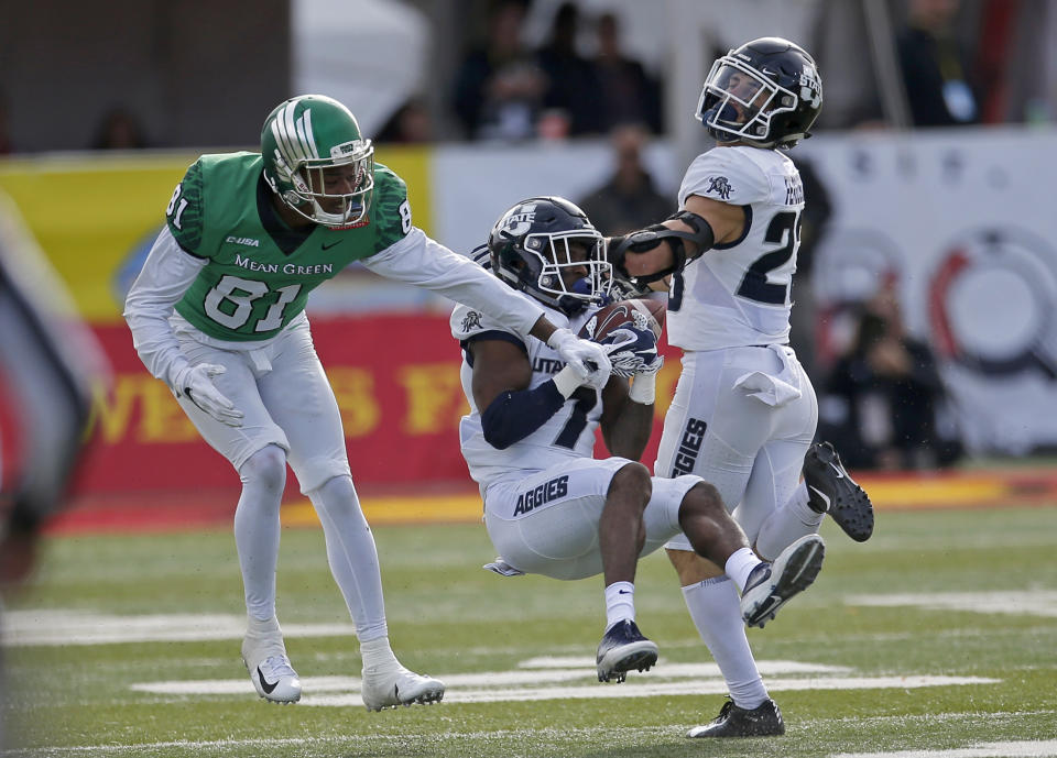 Utah State cornerback DJ Williams (7) intercept a pass intended for North Texas wide receiver Cudjoe Young (81) during the first half of the New Mexico Bowl NCAA college football game in Albuquerque, N.M., Saturday, Dec. 15, 2018. (AP Photo/Andres Leighton)