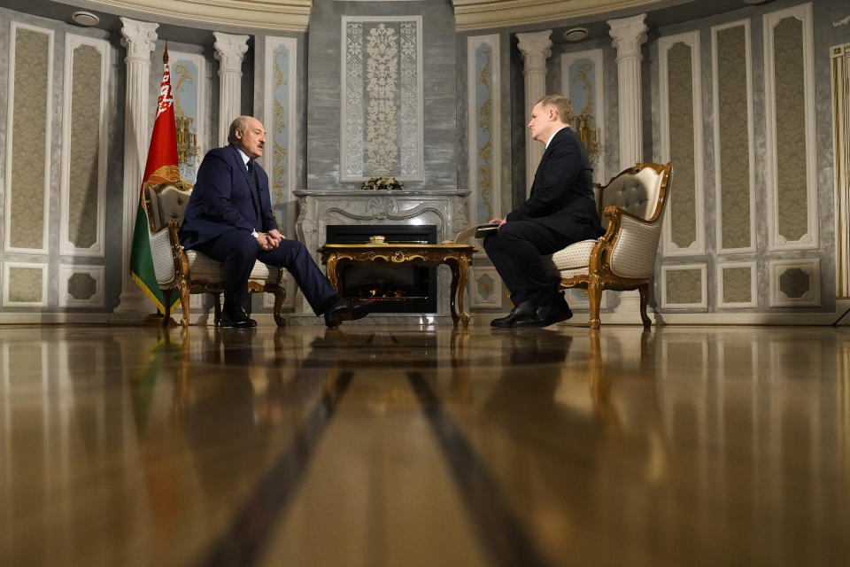 Belarus President Alexander Lukashenko, left, is interviewed by Ian Phillips, Vice President of International News of The Associated Press, at the Independence Palace in Minsk, Belarus, Thursday, May 5, 2022. (AP Photo/Markus Schreiber)