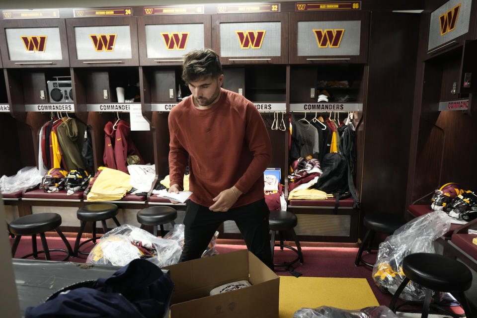 Washington Commanders quarterback Sam Howell packs his belongings from his locker during the NFL football team's open locker room event in Ashburn, Va., Monday, Jan. 9, 2023. (AP Photo/Manuel Balce Ceneta)