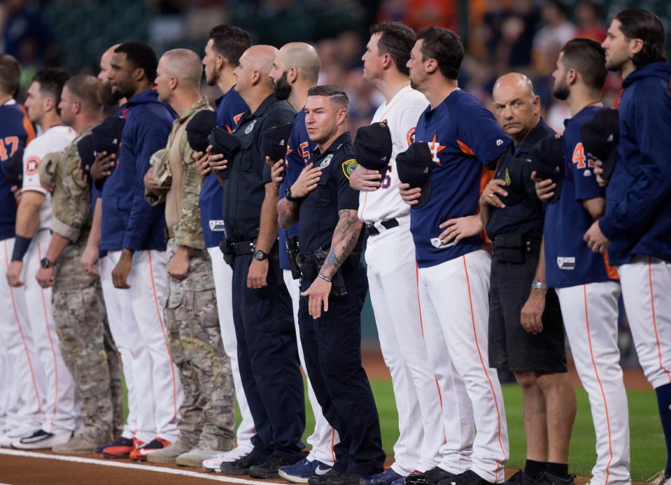 First responders stand with the Houston Astros during the national anthem at Minute Maid Park on Saturday. (Getty Images) 