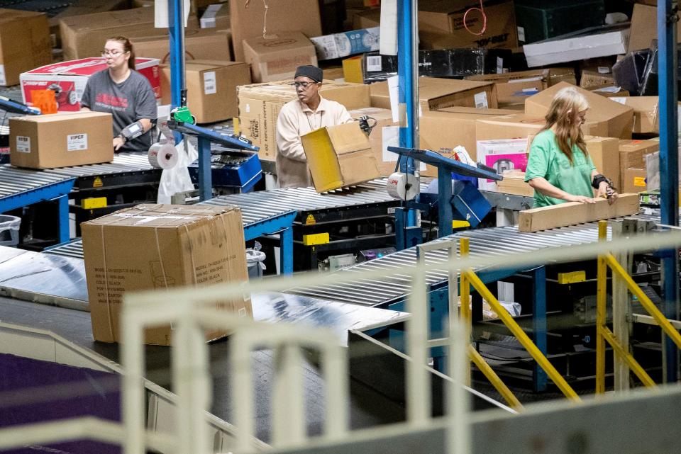 Employees sort packages Wednesday, Dec. 4, 2019, at the FedEx Ground Olive Branch hub.
