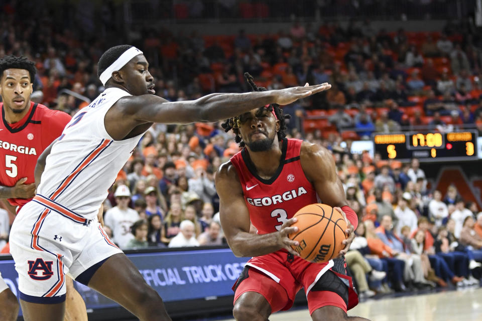 Auburn forward Jaylin Williams blocks a shot by Georgia guard Kario Oquendo (3) during the first half of an NCAA college basketball game, Wednesday, Feb. 1, 2023, in Auburn, Ala. (AP Photo/Julie Bennett)