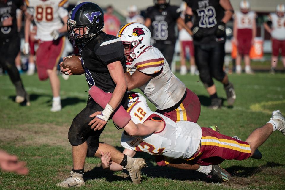 Blackstone Valley Tech's Adam Fransen is tackled by Cardinal Spellman's Umarei Murray and Matt O'Donnell in the Division 6 State Quarterfinal on Saturday afternoon. .