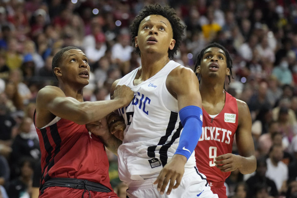 Houston Rockets' Jabari Smith Jr., left, and Orlando Magic's Paolo Banchero look for a rebound during the first half an NBA summer league basketball game Thursday, July 7, 2022, in Las Vegas. (AP Photo/John Locher)