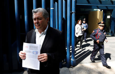 Jaime Martinez, head of the federally-run Commission for Dialogue with Indigenous People stands outside the Mexico's attorney general's office as he holds his complaint against Trump in Mexico City, Mexico January 25, 2017. REUTERS/Carlos Jasso