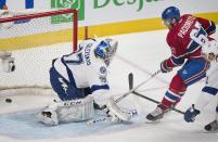 Montreal Canadiens' Max Pacioretty slides in on Tampa Bay Lightning's goaltender Kristers Gudlevskis during second period NHL Stanley Cup playoff action in Montreal, Tuesday, April 22, 2014. (AP Photo/The Canadian Press, Graham Hughes)